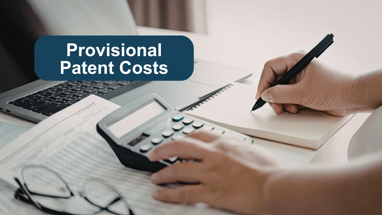 A calculator being used by a person to sum up costs. A banner that says "Provisional patent costs".